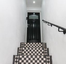 A staircase leading to a door at 14 Brunswick Street Whitby