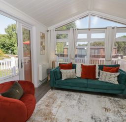 A living room with a sofa and armchair at 73 Cildraeth in New Quay