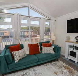 A living room with a sofa and television at 73 Cildraeth New Quay