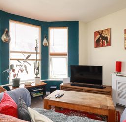 A living room with a couch and television at Seaside Retreat in Newquay