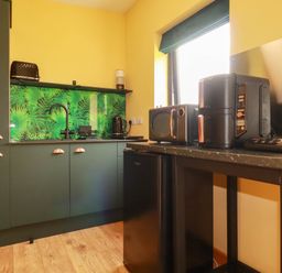 A kitchen with appliances including a refrigerator and microwave at The Hyde, Tazamble cottage, Launceston