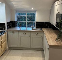 A kitchen with a sink and cabinets at The Old Barn in Manchester