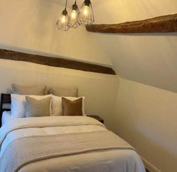 A bedroom with a bed and nightstand at the property