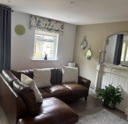 A living room with a sofa and a fireplace at 
