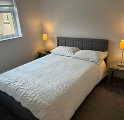 A bedroom with a bed and nightstands at the property in location