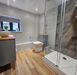 A bathroom featuring a shower, toilet, and sink at Lily's Cottage Suffolk Sleeps 2 with Pets, Mendlesham Green near Stowmarket