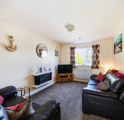 A living room with a television and sofa at Seaside Chalet Retreat in Bridlington