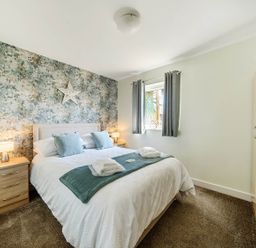 A bedroom with a bed and bedside tables at Seaside Chalet Retreat in Bridlington