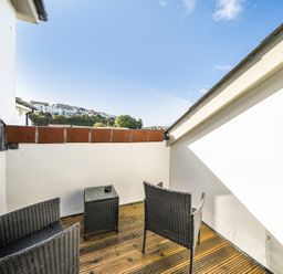 A balcony with two chairs and a table at Apartment Sleeps 4 with Balcony and Parking in Kingsbridge