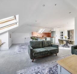 A living room with a sofa and dining area at Apartment Sleeps 4 with Balcony and Parking in Kingsbridge