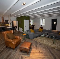A living room with a sofa and armchair at Stunning 3 Bed Converted Village Hall Near Kelso Nenthorn near Kelso