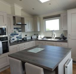 A kitchen with cabinetry and appliances at 2 Bedroom Sleeps 4 Lodge Smart Tv Hot tub Dogs Ok near Lochwinnoch