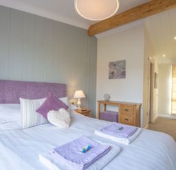 A bedroom with a double bed and side table at 2 Bedroom Sleeps 4 Lodge Smart Tv Hot tub Dogs Ok near Lochwinnoch