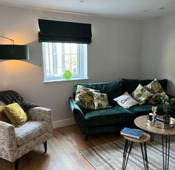 A living room with a sofa, armchair, and coffee table at Yr Hen Beudy Barn Conversion Sleeps 4 Dogs Ok near Brodle Farm near Llansteffan