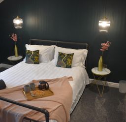 A bedroom with bed and tea set at Yr Hen Beudy Barn Conversion Sleeps 4 Dogs Ok Brodl Farm near Llansteffan