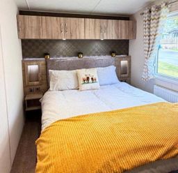 A bedroom with a bed and window at Lillardsedge Luxury Caravan Sleeps 6 with Parking near Lilliardsedge Holiday Park