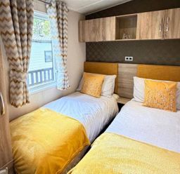 A bedroom with two beds and window at Lillardsedge Luxury Caravan Sleeps 6 with Parking near Lilliardsedge Holiday Park