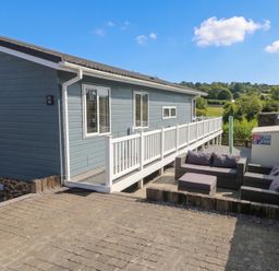 An outdoor seating area with furniture at Pleasant Valley Holiday Lodge 70 Stepaside