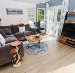 A living room with a sofa and coffee table at Pleasant Valley Holiday Lodge 70 Stepaside