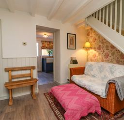 A living room with a sofa and stove at Blue Cottage in Malton