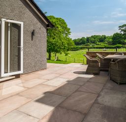An outdoor seating area with chairs and a view of a field at Bay Bungalow
