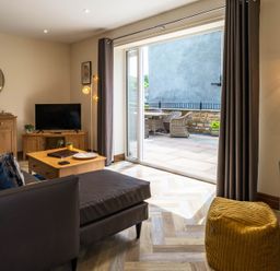 A living room with a television and coffee table at Bay Bungalow 