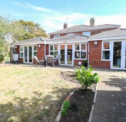 A garden with a patio area and seating at The Mill House Apartment 