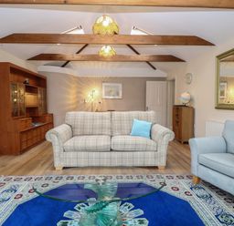 A living room with a sofa and coffee table at The Mill House Annexe Oulton Broad