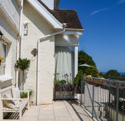 An outdoor area with a bench and planters at Elberry Cove View in Paignton