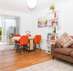 A dining room with a table and chairs at Elberry Cove View, Paignton