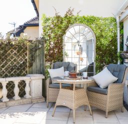 An outdoor seating area with a table and chairs at Elberry Cove View in Paignton