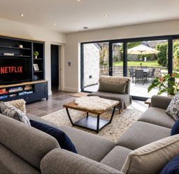A living room with a television and sofa at Rheidiol in St Davids