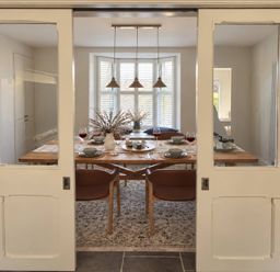 A dining room with a table set for dinner at Rheidiol St Davids