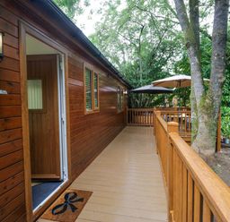 An outdoor area with wooden decking and an entrance at Fir Tree Lodge, White Cross bay on Windermere, Troutbeck Bridge