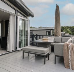 A balcony with outdoor sofa and coffee table at Lakewood Plot 7 in Clacton-on-Sea