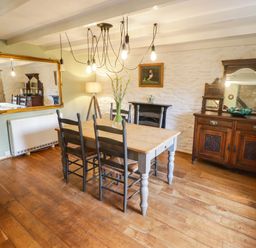 A dining room with a table and chairs at Ty'r Wennol in Fishguard