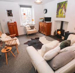 A living room with a sofa and a television at 11 Church Street in Narberth