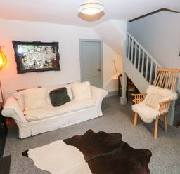 A living room with a sofa and rocking chair at 11 Church Street Narberth
