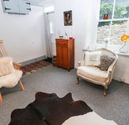 A sitting room with a rocking chair and an armchair at 11 Church Street Narberth