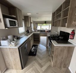A kitchen with appliances and storage at West Lawn 47 Haggerston Castle Paddock Views Haggerston