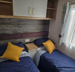 A bedroom with two beds and a wardrobe at 3 Bed-Sleeps 8-Free Parking-5 Min to Beach Embo near Dornoch