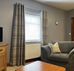 A living room with a tv and a sofa at Milecastle Inn on Hadrian's Wall near Haltwhistle