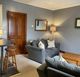 A living room with a sofa and coffee table at Milecastle Inn on Hadrian's Wall near Haltwhistle