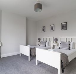 A bedroom with two beds and bedside tables at East House-Sleeps 5-Pet friendly-Garden-Parking in Stakeford