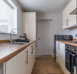 A kitchen with a sink and appliances at East House-Sleeps 5-Pet friendly-Garden-Parking in Stakeford