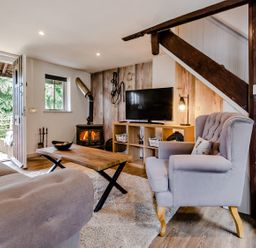 A living room with a wooden coffee table and television at Cottage - Sleeps 4 - Parking Evesham