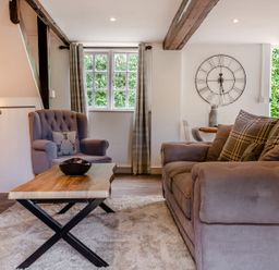A living room with a sofa and an armchair at Cottage - Sleeps 4 - Parking in Evesham
