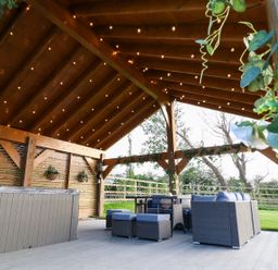 An outdoor area with seating and a hot tub at Northumberland Luxury Stays - The Chivits near West Chevington