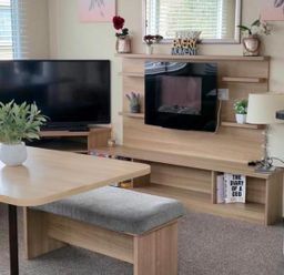 A living room with a television and a coffee table at Port Haverigg Cabin Sleeps 4 Steel Green near Haverigg