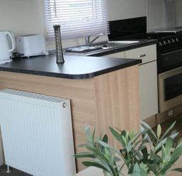 A kitchen with a stove and sink at Port Haverigg Cabin Sleeps 4 Steel Green near Haverigg